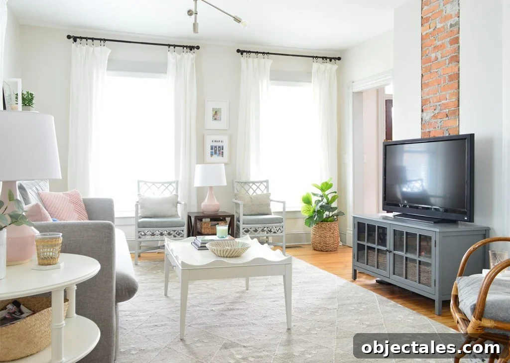 TV in gray neutral bright living room against exposed brick chimney