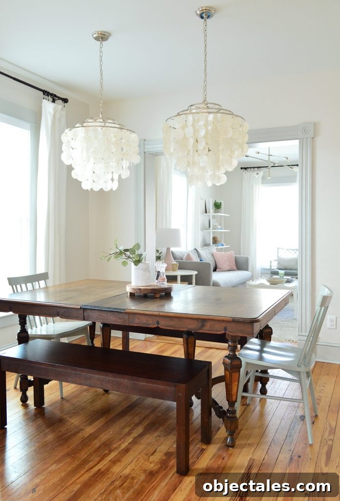 vintage dining table with two capiz chandeliers over top