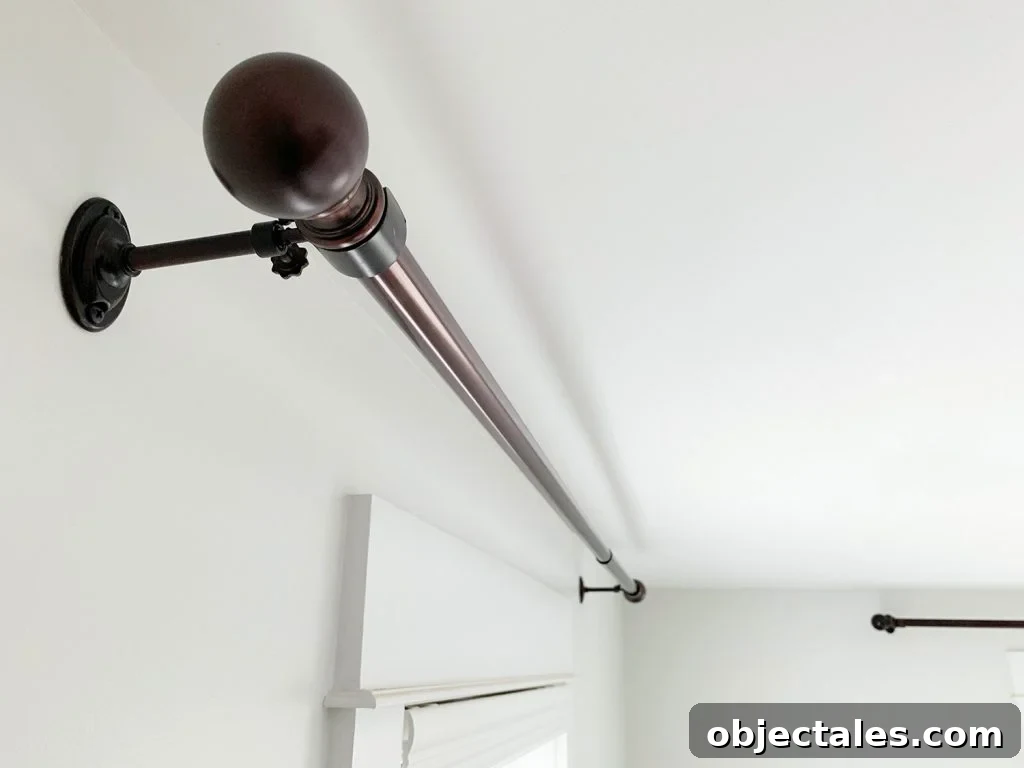 Allen + Roth Bronze curtain rods hung against white wall