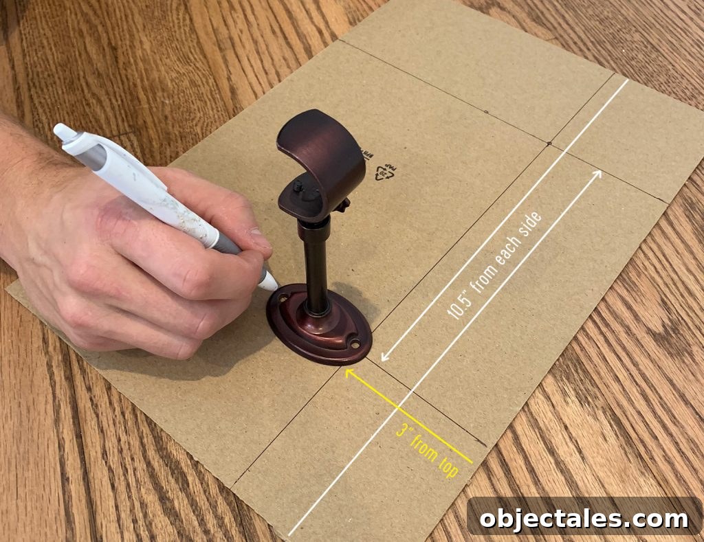 Marking lines on cardboard to make a curtain rod hanging template