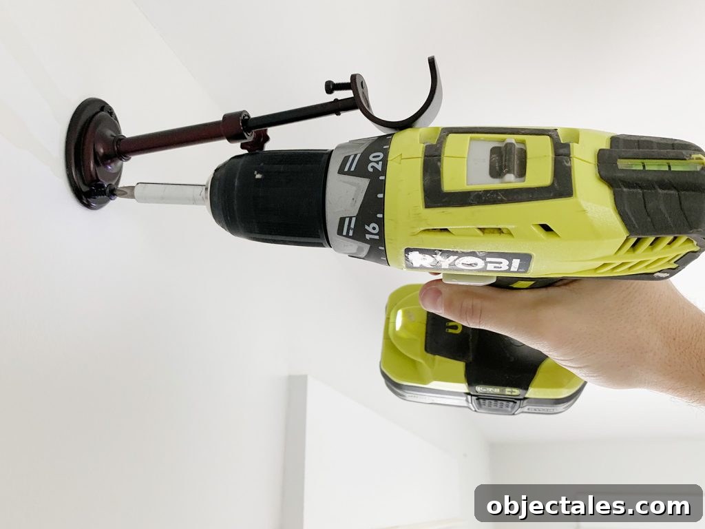 Attaching curtain rod hook using power drill