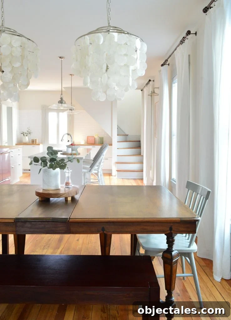 Row of curtains hung in beach house dining room using dark bronze curtain rods.