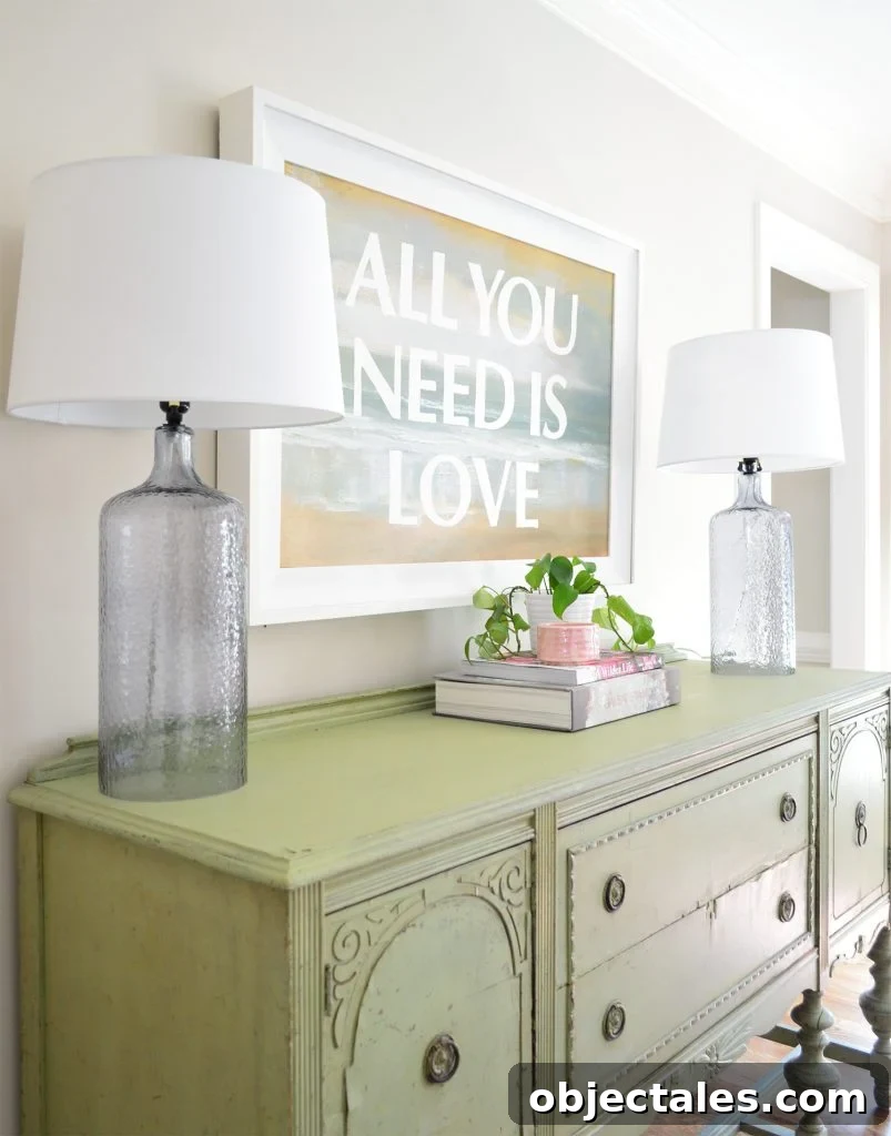 Low-Maintenance Houseplants and Realistic Faux Plants 3 Dining room with vintage green buffet and green ivy plant under All You Need Is Love painting