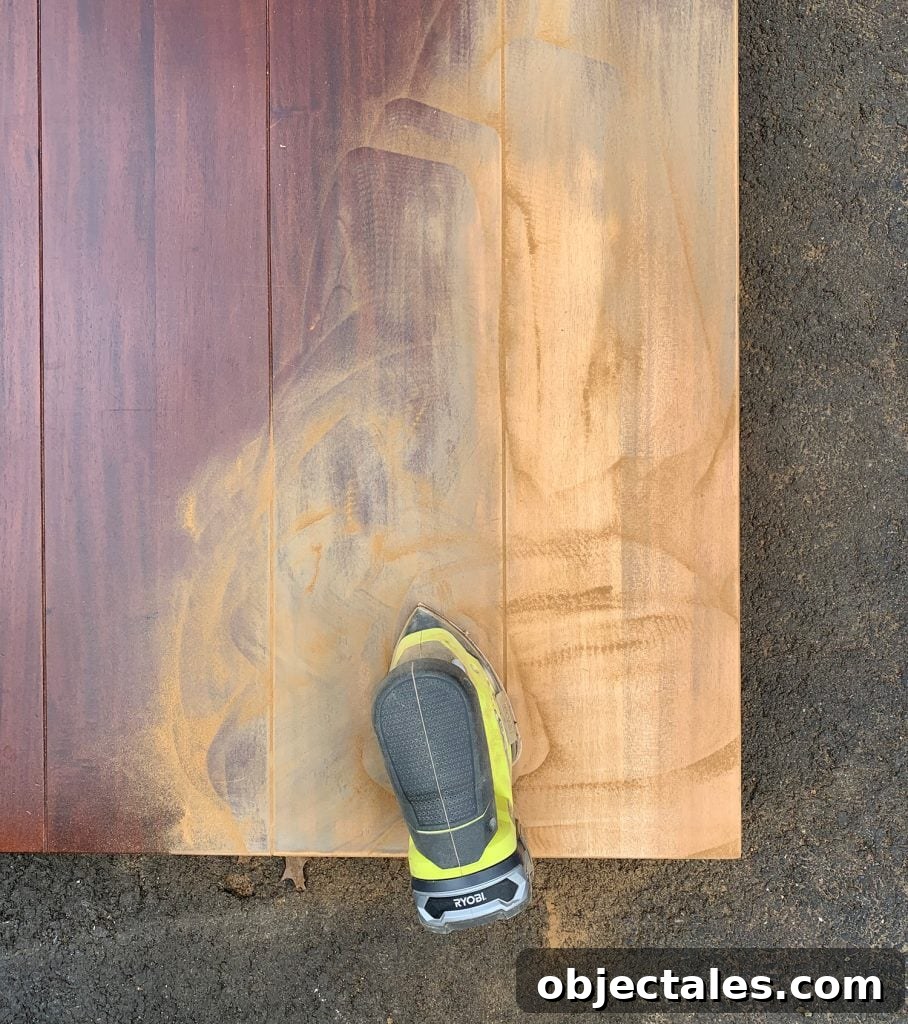 Refinish Your Table: Step-by-Step Guide to a Smooth Finish 2 Sanding the finish off of a wood dining table to refinish it with new stain