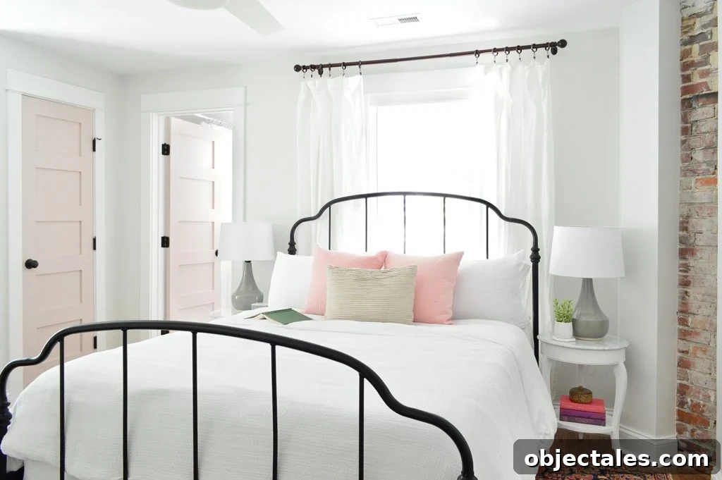Back bedroom with bed, side tables, lamps