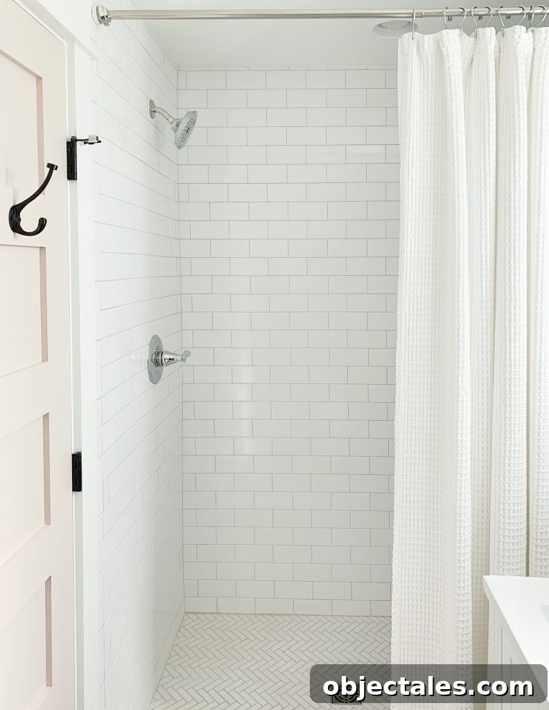 Shower with white tile and curtain