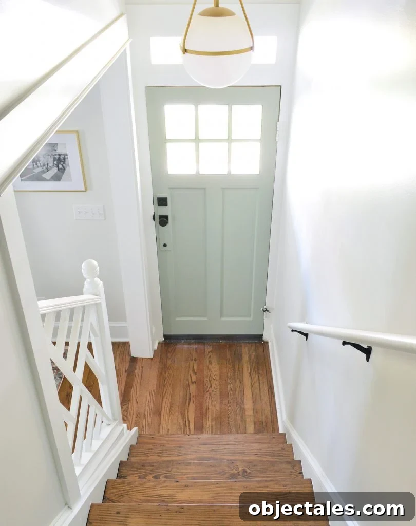 Open stairwell with railing and light fixture