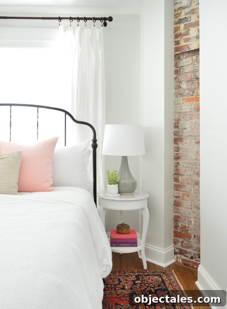 Exposed brick chimney in bedroom