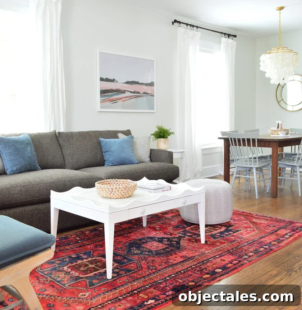 Duplex Living and Dining Room Makeovers Revealed 2 Scallop Coffee Table on Red Rug With Crate And Barrel Sofa