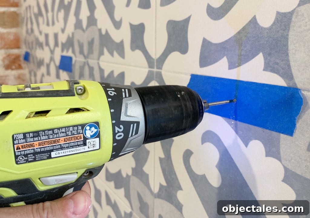 How to Drill Through Tile Without Cracking or Chipping 10 Drilling Through Tile Backsplash Using Marked Spot With Painters Tpae