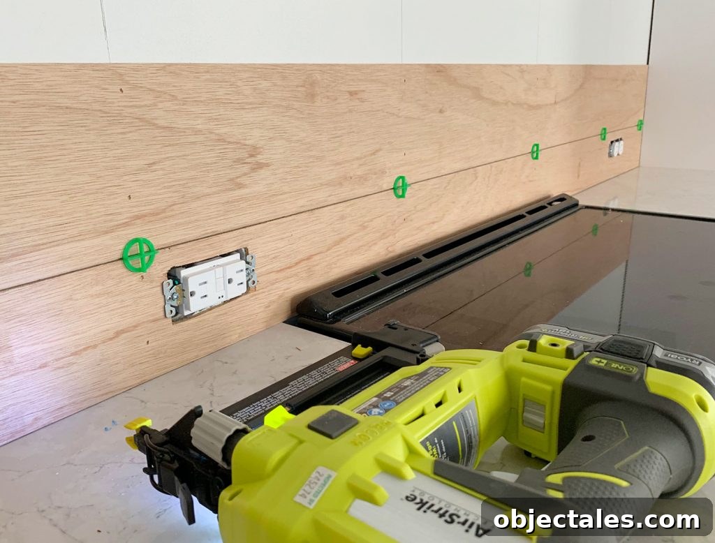 Shiplap Wall Plank Makeover for Just 31 Dollars 18 First Two Panel Strips Installed Using Nail Gun and Green Tile Spacers