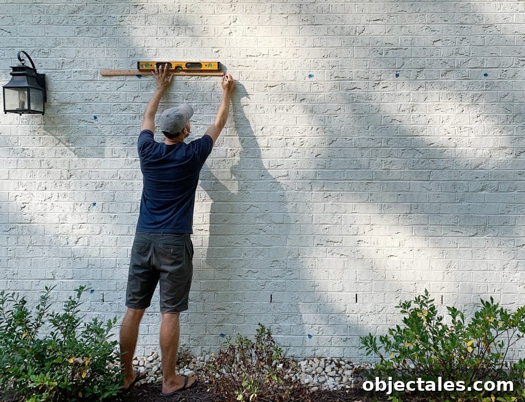 Build a DIY Garden Trellis: Step-by-Step Guide 8 John Marking Trellis Hooks On Brick Wall