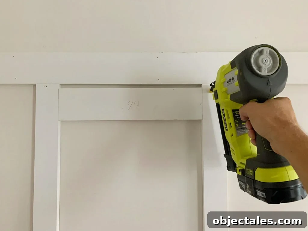 Installing Vertical Battens Using Nail Gun And Wood Spacer