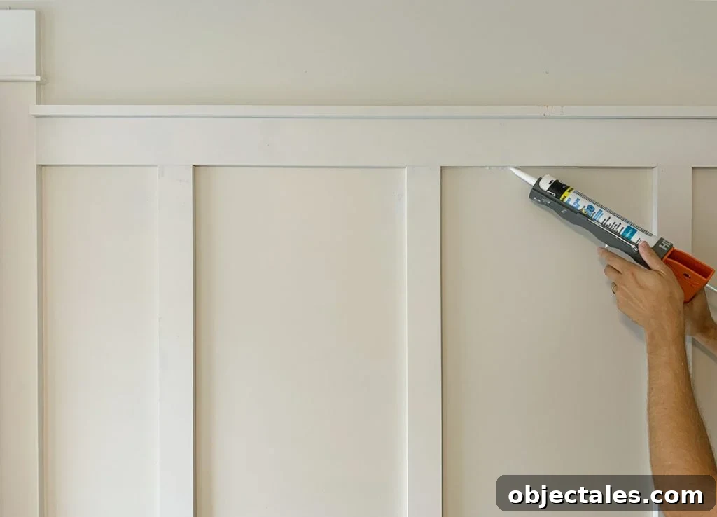 Applying Caulk Bead To Seams On Board And Batten Installation