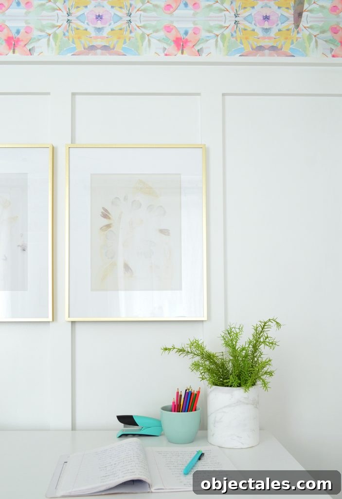 Desk With Gold Frames Hung On White Board And Batten
