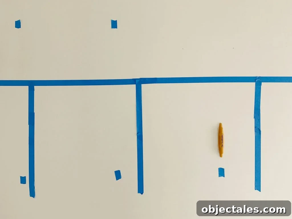 Marking Studs With Blue Painters Tape Using Stud Buddy Tool