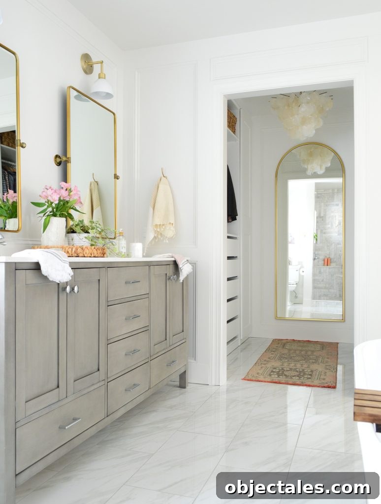 Marlbe bathroom with gray double vanity and doorway into walk in closet