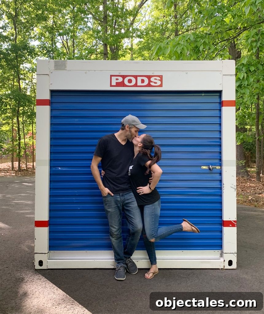 John and Sherry kissing in front of moving PODS storage container