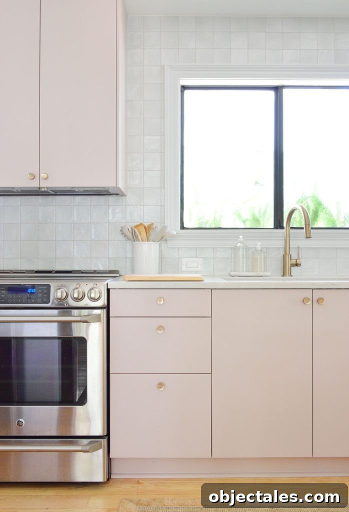 Vertical View Of Mauve Pink Painted Ikea Kitchen Cabinets With Gray Tile Backsplash
