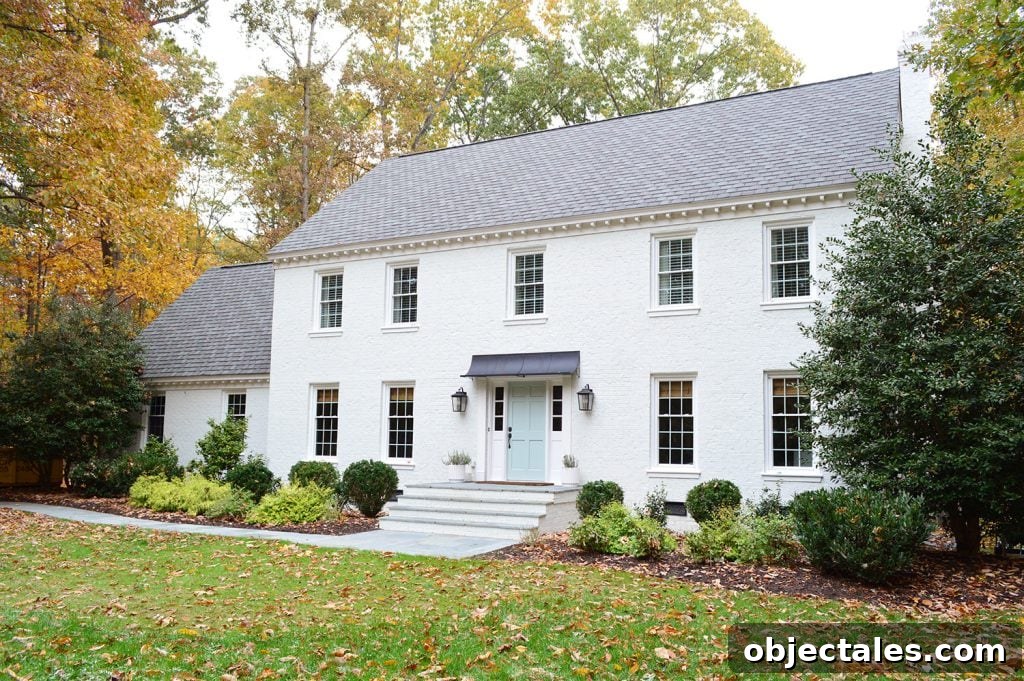 What We Changed After Painting Our Brick House White 3 This image has an empty alt attribute; its file name is White-Brick-Exterior-Fall-Path-From-Right-1024x681.jpg