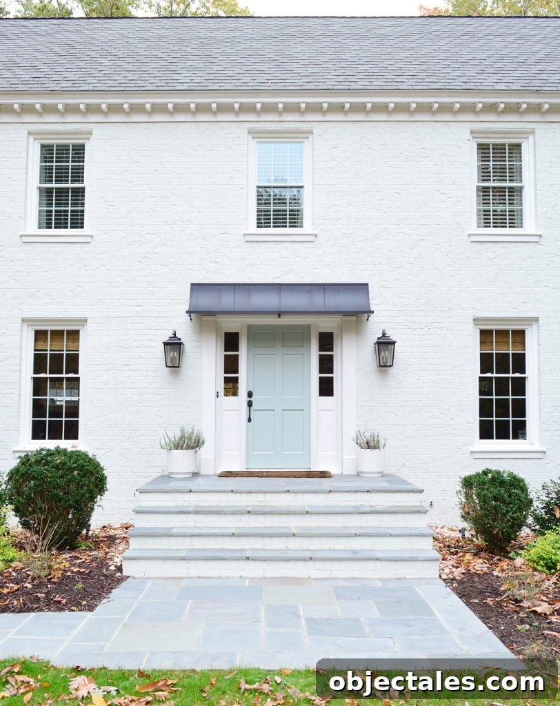 What We Changed After Painting Our Brick House White 6 This image has an empty alt attribute; its file name is White-Brick-Exterior-Fall-Path-Straight-Porch-Detail-812x1024.jpg