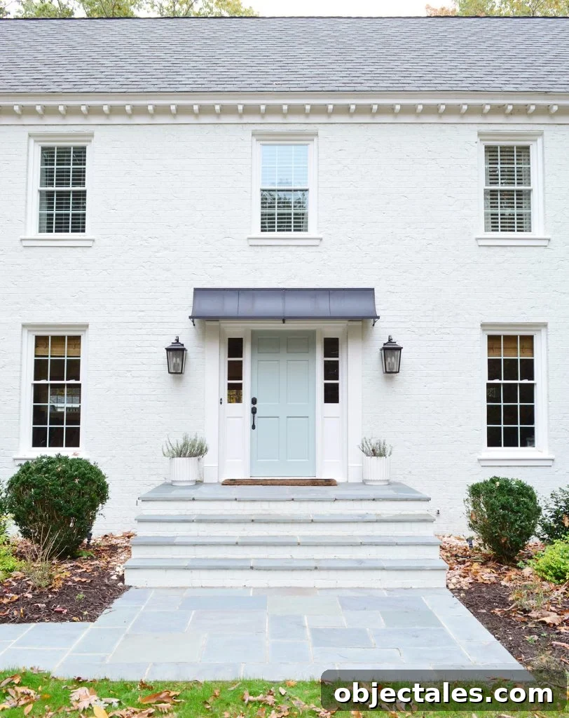 This image has an empty alt attribute; its file name is White-Brick-Exterior-Fall-Path-Straight-Porch-Detail-812x1024.jpg