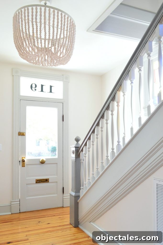 7 Beach House Updates: What We Changed and Why 7 Beaded Chandelier In Beach House Foyer With Glass Door