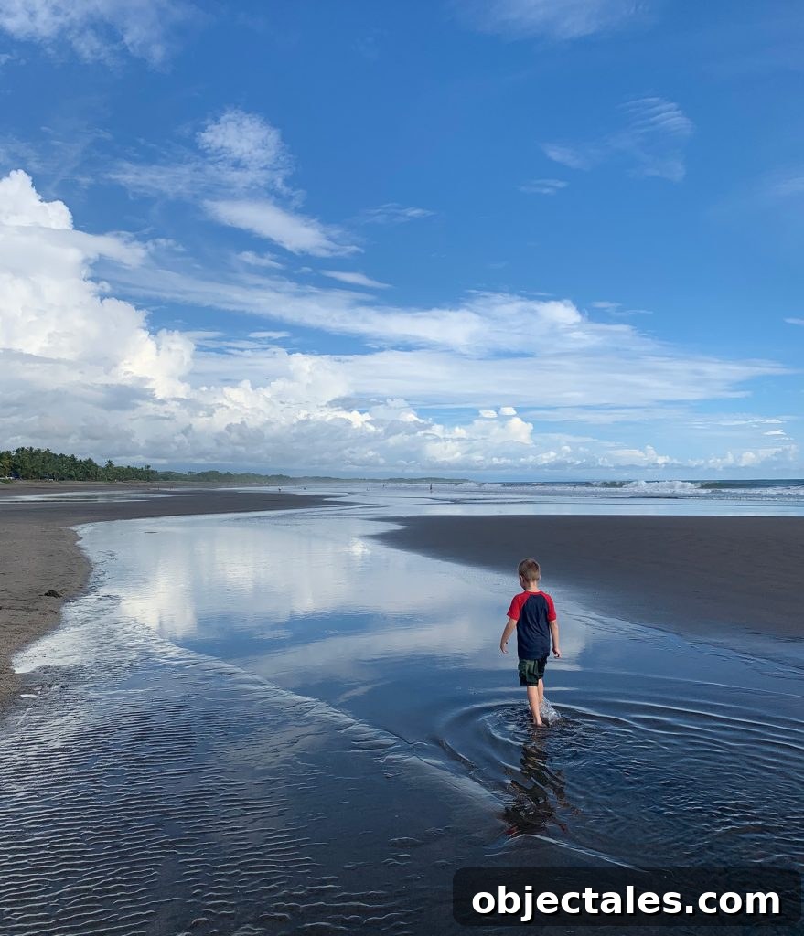 Costa Rica Family Travel: Top Activities and Tips 11 Young Boy Playing In Tide Pool at Esterillos Oeste Beach In Costa Rica