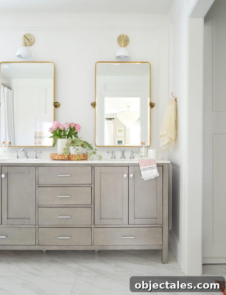 Bathroom Makeover Before and After Photos and Total Cost 5 Traditional Gray Double Vanity In Bathroom With Brass Pivot Mirrors And Shades Of Light Dapper Sconce