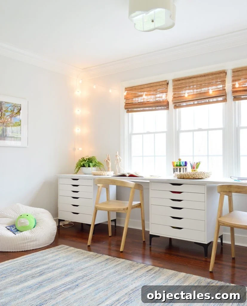 Kids Art Room With Two Wood Chairs Along Long Art Desk Workspace With String Lights