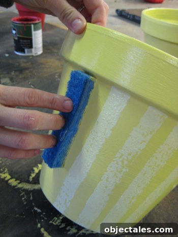 sponging striped paint pattern to terra cotta pot