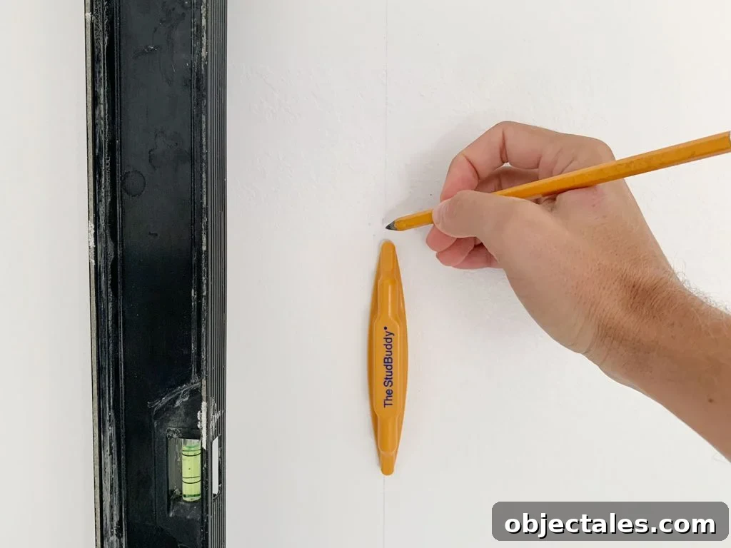 Hand Marking Vertical Level Line On Wall Using StudBuddy Stud Finder