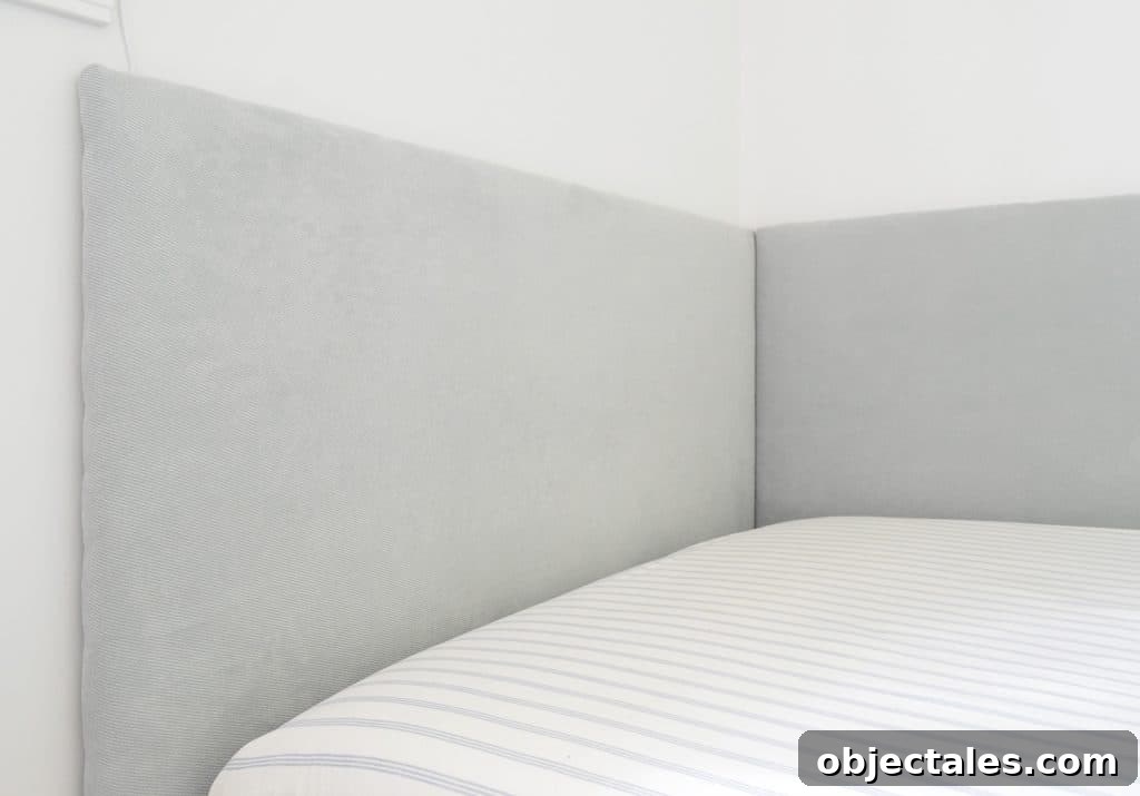 Close up of finished DIY headboard on two sides of built-in daybed in boys bedroom