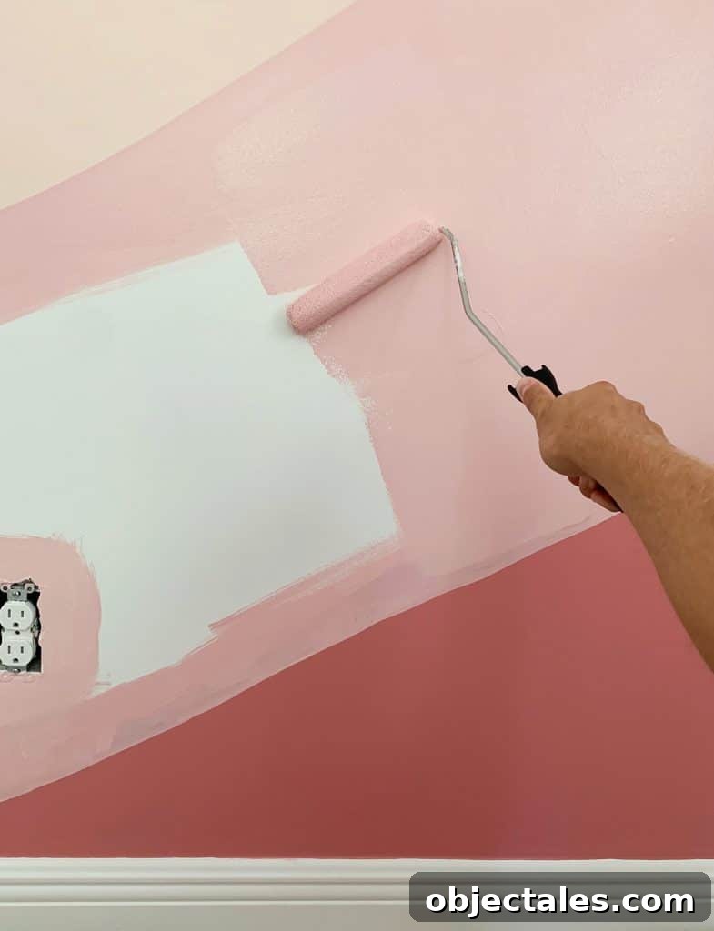Filling in abstract mural with paint roller