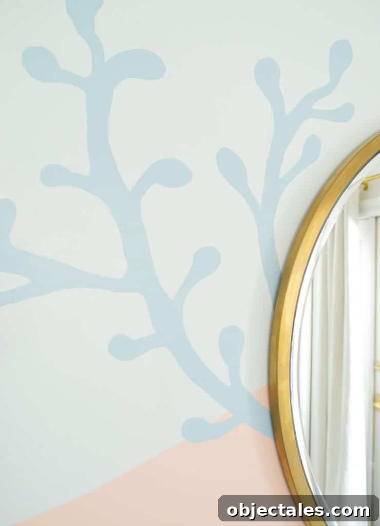 Blue coral shape painted onto abstract mural in beachy girls bedroom