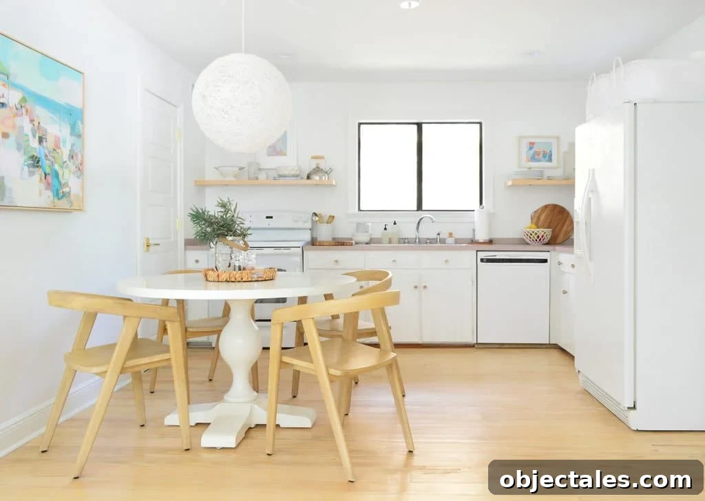 5 Quick Kitchen Upgrades That Transform Your Space 4 Minimal Kitchen With White Cabinets Pedestal Table And Globe Pendant Light With Wood Chairs