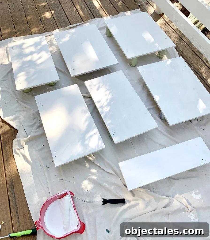 How to Paint Kitchen Cabinets Pink: Tips and Color Ideas 13 Cabinet doors laid on drop cloth with coat of white primer drying