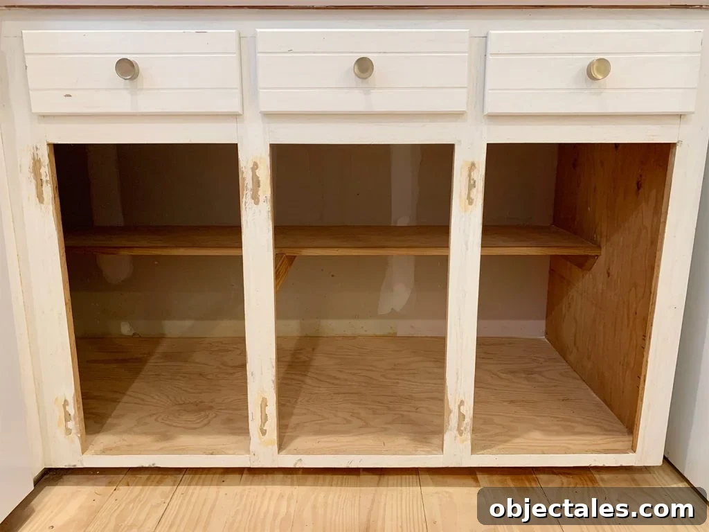 How to Paint Kitchen Cabinets Pink: Tips and Color Ideas 15 Three lower cabinet frames sanded and holes filled with wood filler