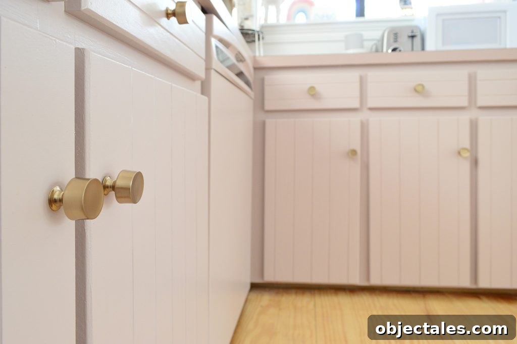How to Paint Kitchen Cabinets Pink: Tips and Color Ideas 19 Close up after photo of mauve cabinets with brass gold hardware knobs