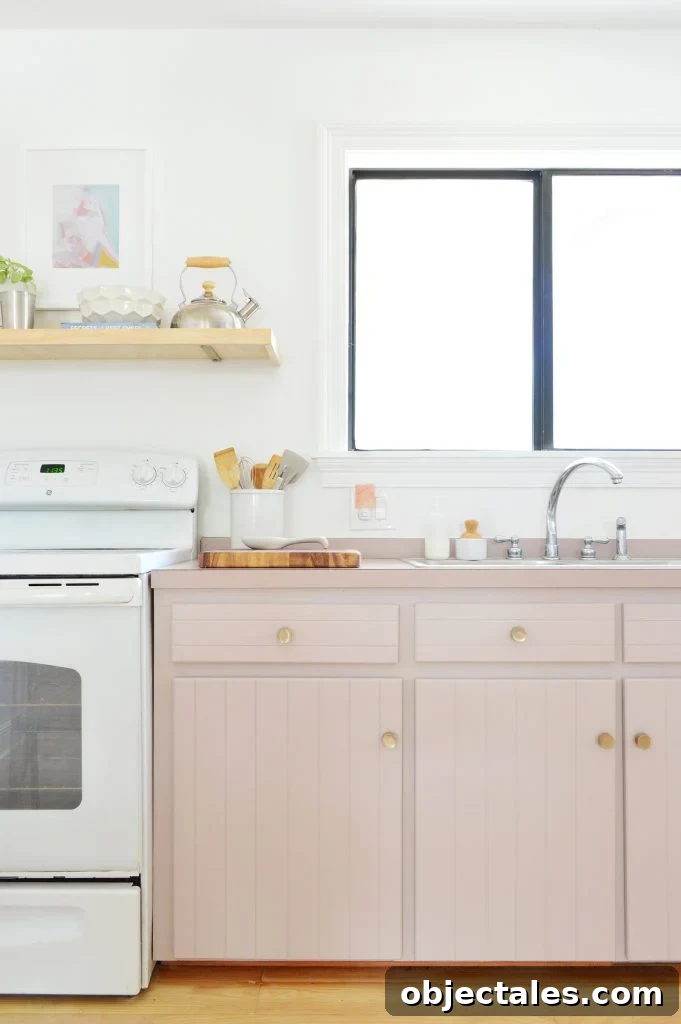 Before and After: Pink Kitchen Cabinets Makeover 4 Old cabinets painted Artsy Pink with mauve laminate counters and white stove