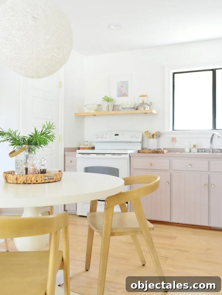 Before and After: Pink Kitchen Cabinets Makeover 7 Simple white kitchen with mauve Artsy Pink cabinets and pedestal table