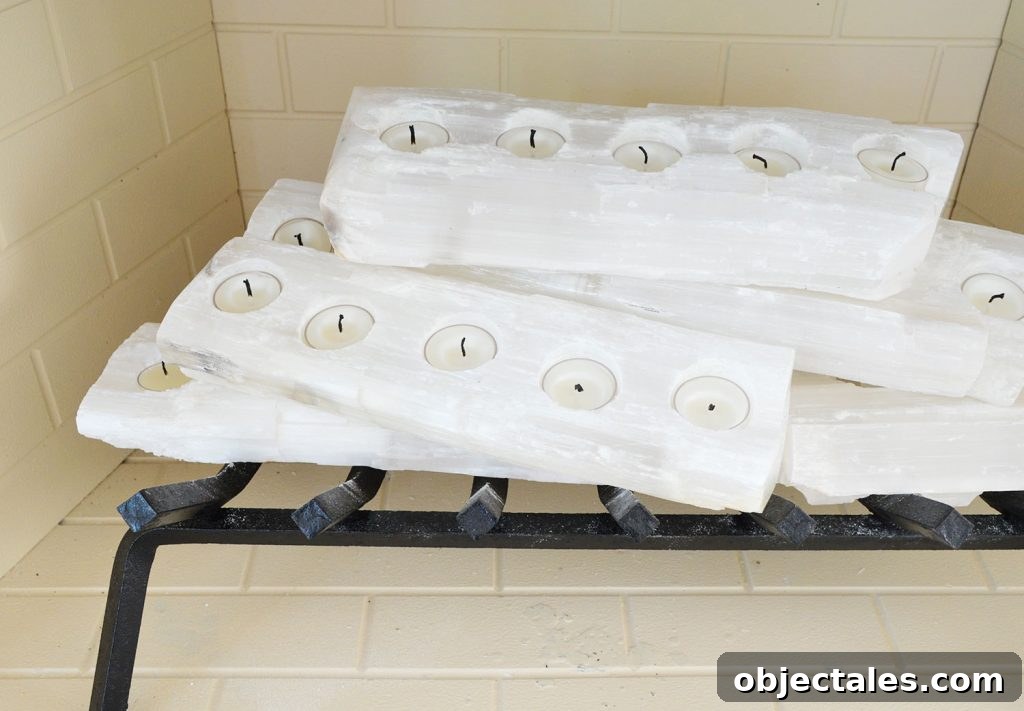 Close-up on crystal logs in fireplace with candles unlit