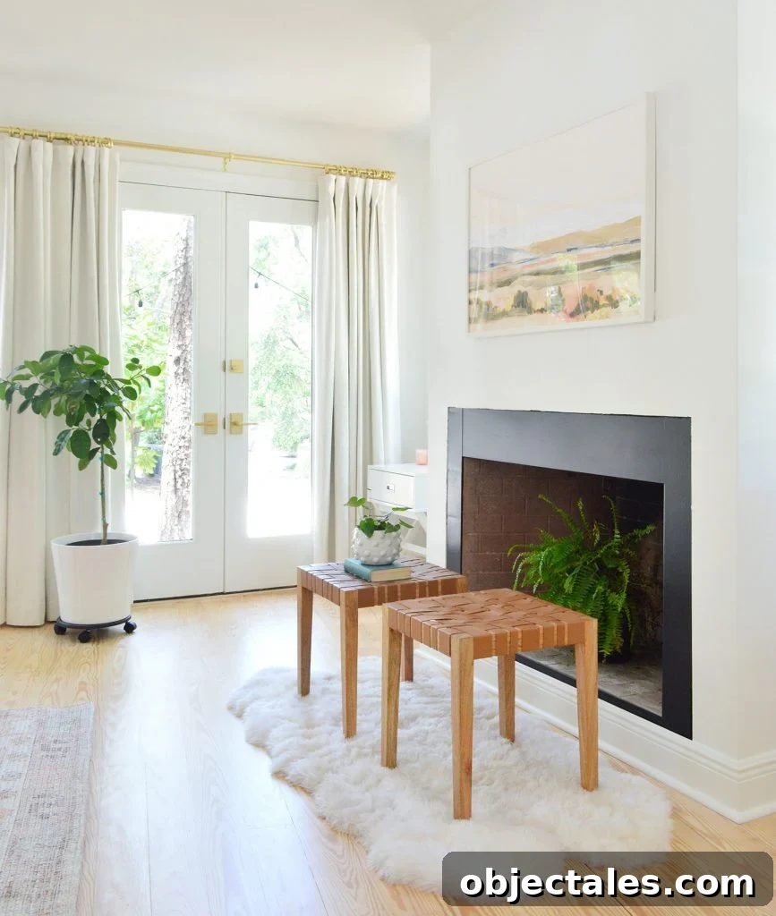 Bedroom fireplace with black border and fern in firebox