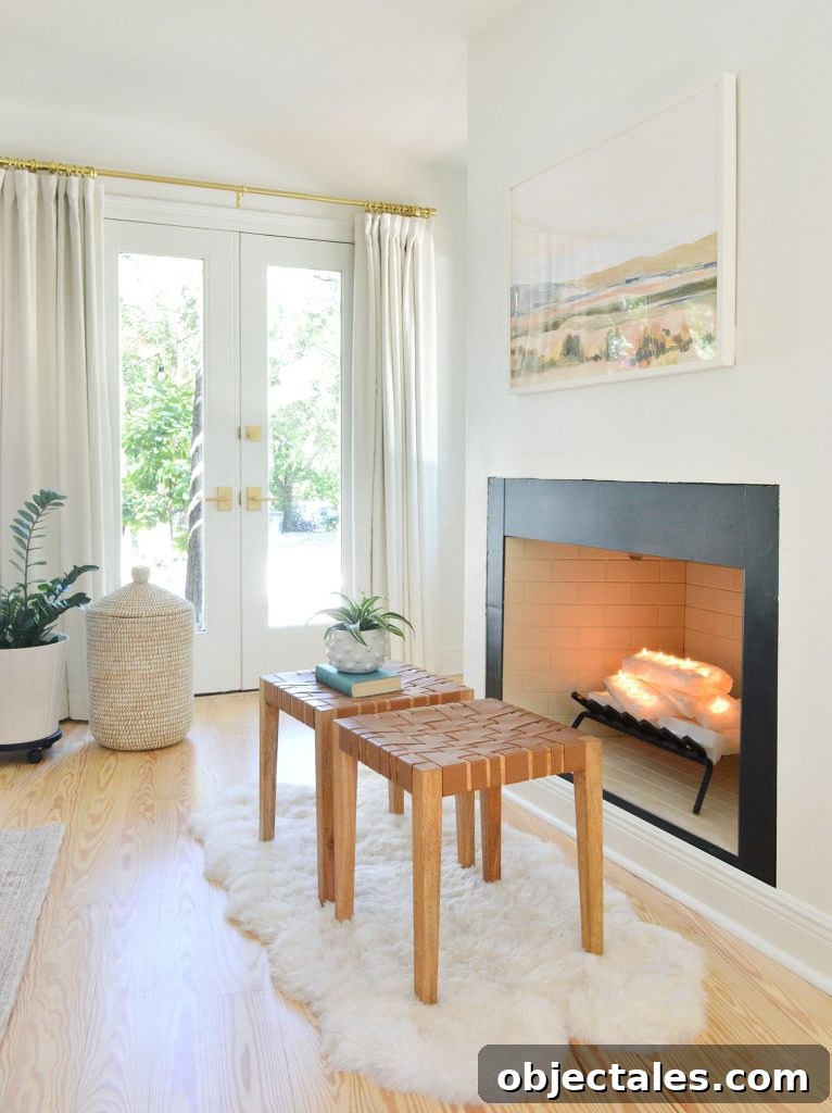 Bedroom fireplace with white crystal logs stacked like firewood and candles lit