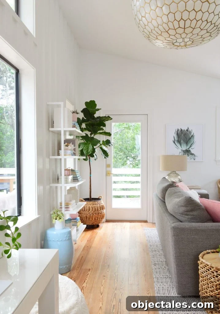 View Of Door To Deck Behind Couch With Large Capiz Light Fixture Overhead
