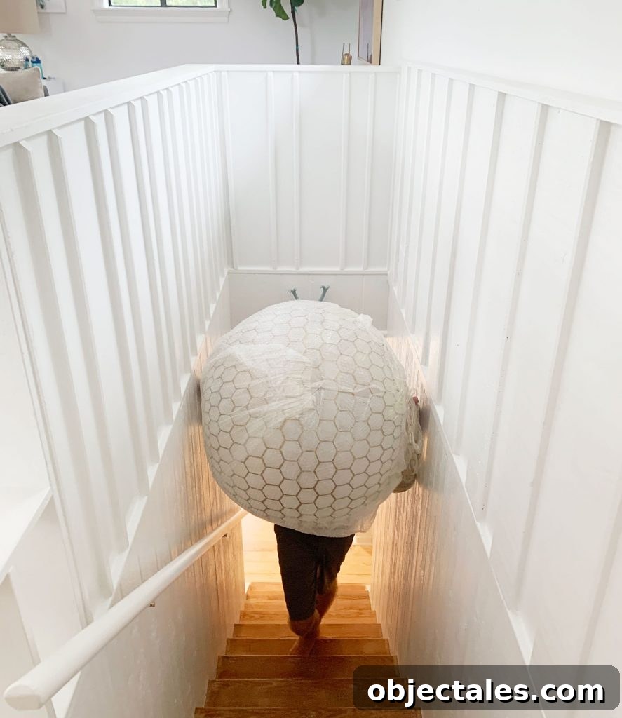 Oversized Capiz Globe Light Narrowly Fitting Up Stairs