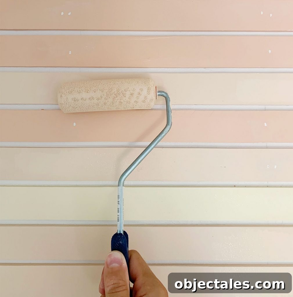 How to Create a Colorful Wood Accent Wall 18 Small Foam Roller Doing Touch Up On Orange Painted Stripe