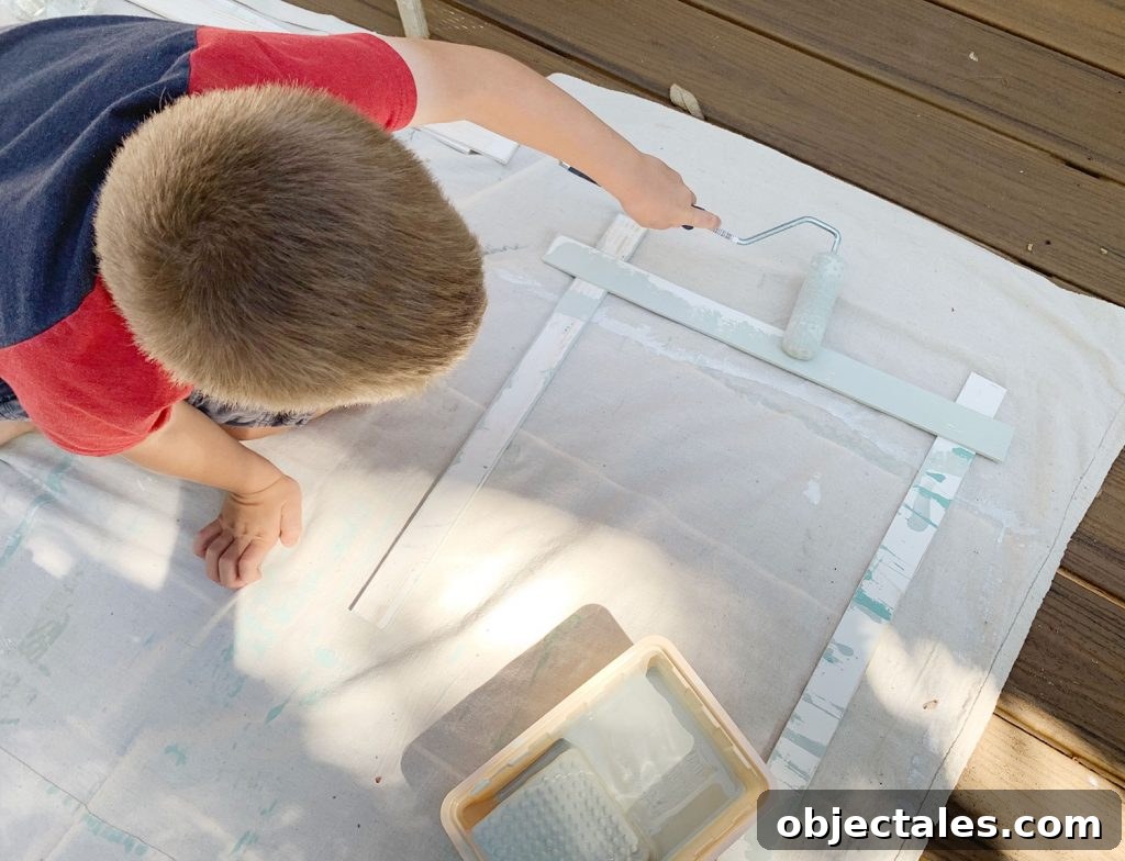 How to Create a Colorful Wood Accent Wall 8 Young Boy Painting Wood Piece With Small Foam Roller