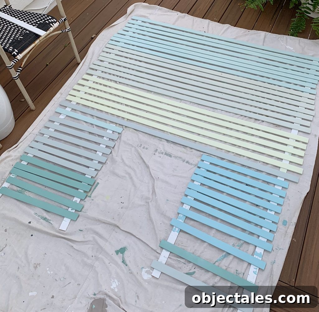 How to Create a Colorful Wood Accent Wall 9 Painted Lattice Strips Laid Out On Deck In Various Blue Green And Gray Colors