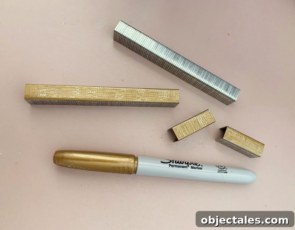Strips of Staples Colored Gold With Sharpie Marker